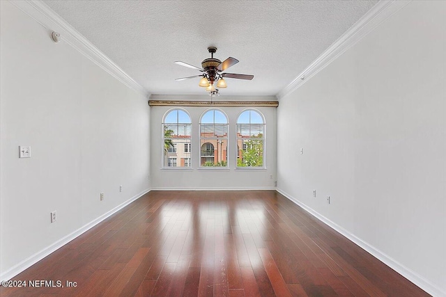 empty room with ornamental molding, dark wood-type flooring, and a textured ceiling