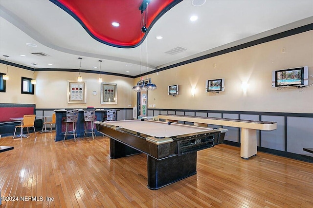 game room with pool table, crown molding, light hardwood / wood-style flooring, and bar