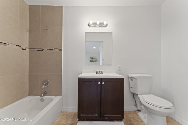 full bathroom featuring tiled shower / bath, vanity, toilet, and tile patterned floors