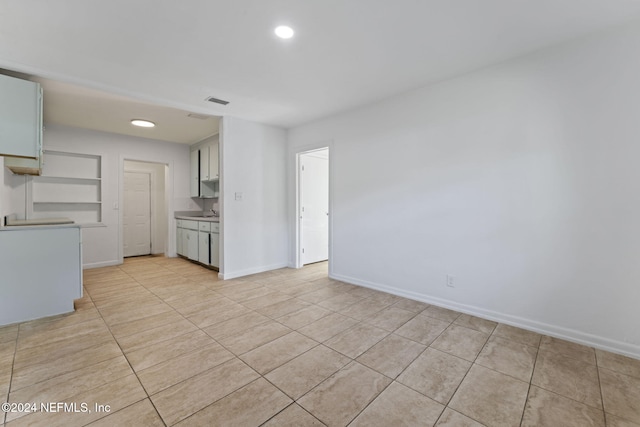 unfurnished living room featuring light tile patterned flooring