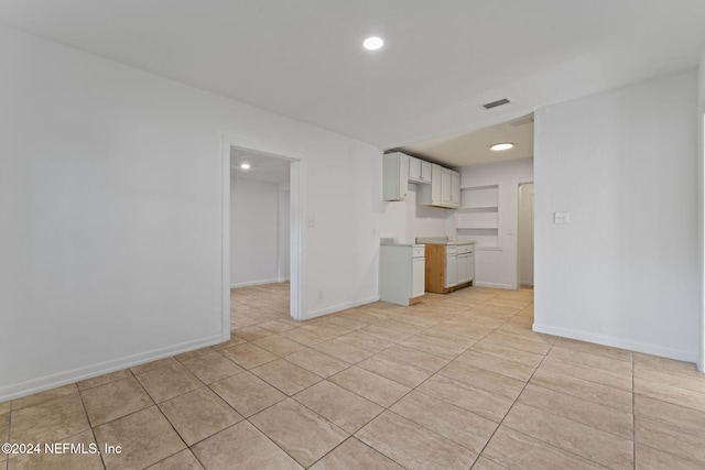 unfurnished living room with light tile patterned flooring