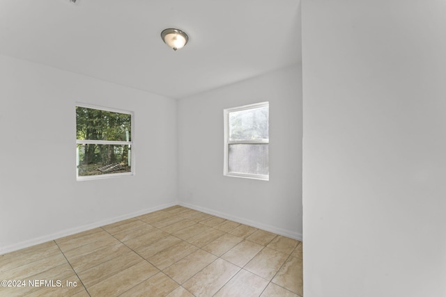 unfurnished room with light tile patterned floors