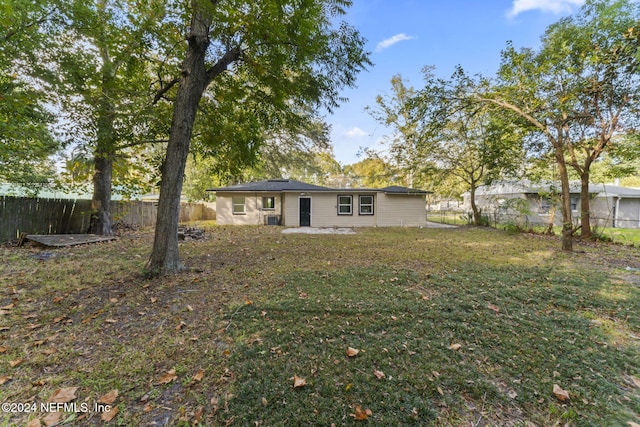 rear view of property with a lawn