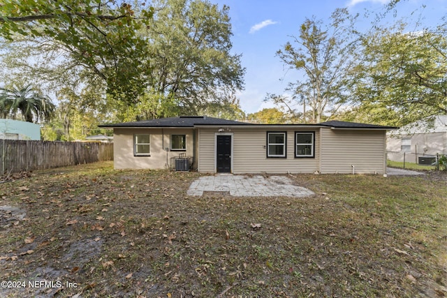 rear view of house with cooling unit and a patio