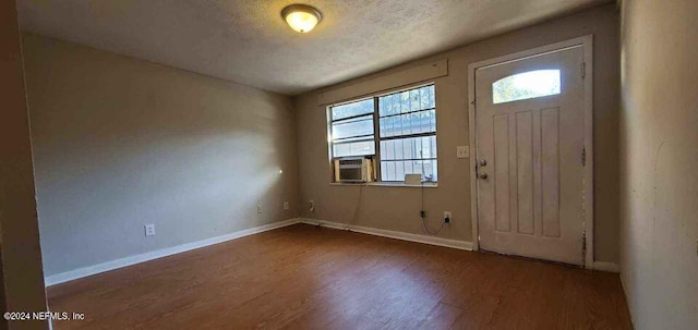 1657 Union St W, Jacksonville, FL 32209 - entrance foyer featuring cooling unit, a textured ceiling, and dark hardwood / wood-style flooring