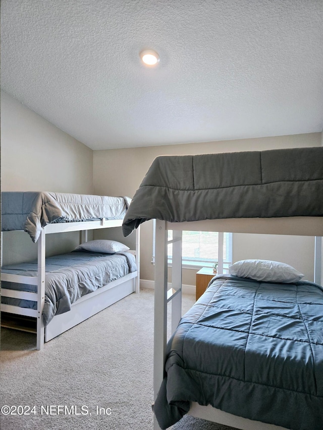 carpeted bedroom featuring a textured ceiling