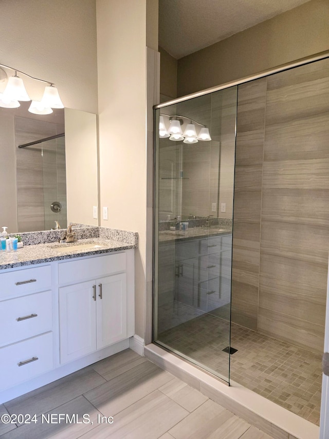 bathroom featuring an enclosed shower and vanity