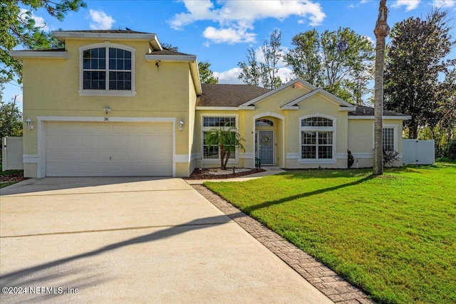 view of front facade with a front yard and a garage