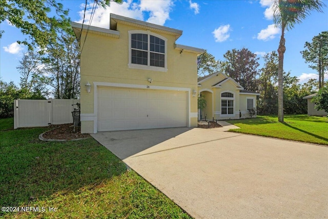 view of front facade with a garage and a front lawn