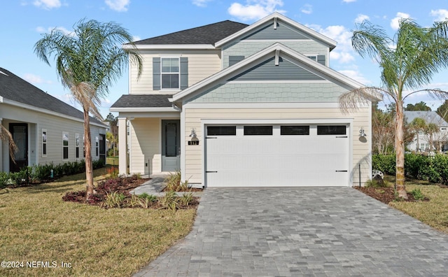 view of front of property featuring a garage and a front lawn