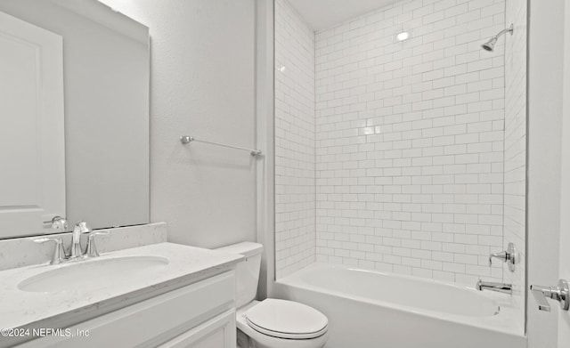 full bathroom featuring vanity, toilet, and tiled shower / bath