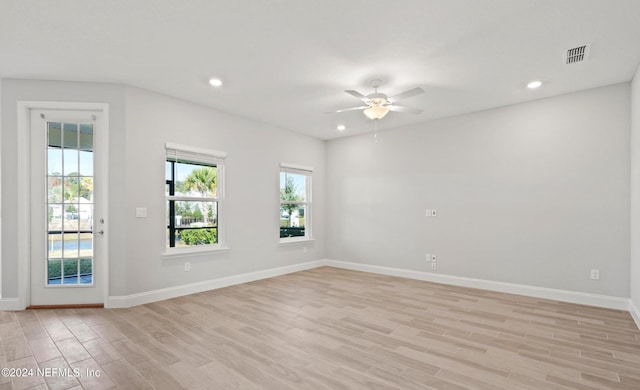 spare room with ceiling fan and light hardwood / wood-style floors