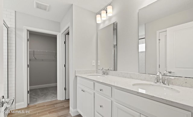 bathroom with hardwood / wood-style floors and vanity