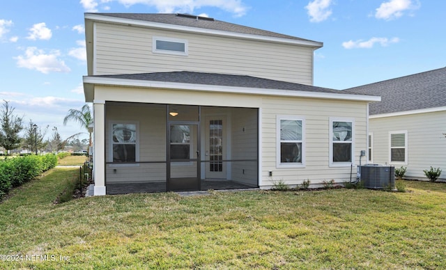 back of property with central air condition unit, a lawn, and a sunroom