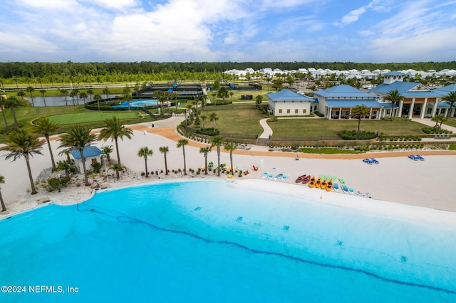 view of pool featuring a water view and a view of the beach