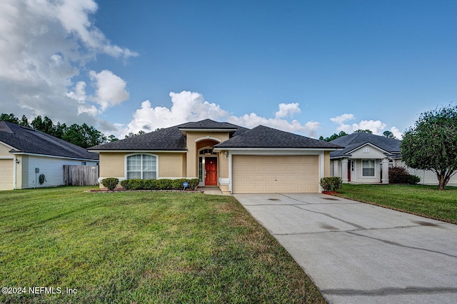 view of front of house featuring a garage and a front lawn