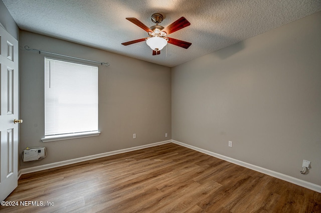 spare room with hardwood / wood-style floors, a textured ceiling, and ceiling fan