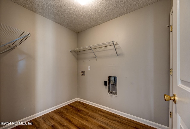 laundry area featuring hardwood / wood-style floors, hookup for a washing machine, and a textured ceiling