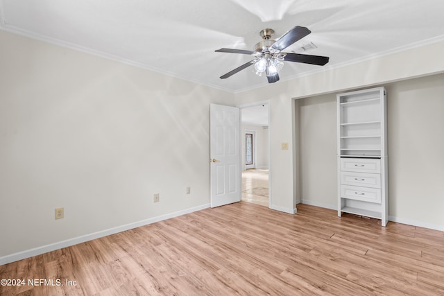 unfurnished bedroom with ornamental molding, light wood-style flooring, baseboards, and a ceiling fan