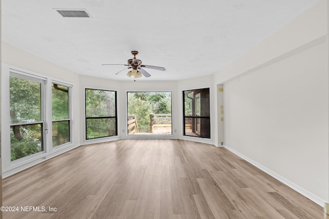 spare room featuring light wood-type flooring and ceiling fan