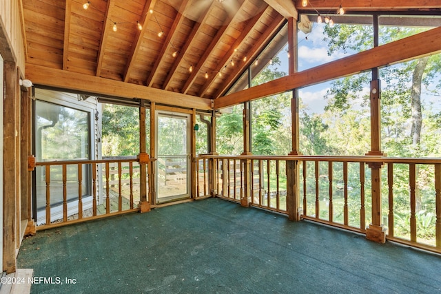 unfurnished sunroom with lofted ceiling with beams, wooden ceiling, and plenty of natural light