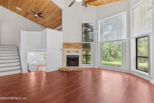 unfurnished living room featuring wooden ceiling, stairs, a ceiling fan, and wood finished floors