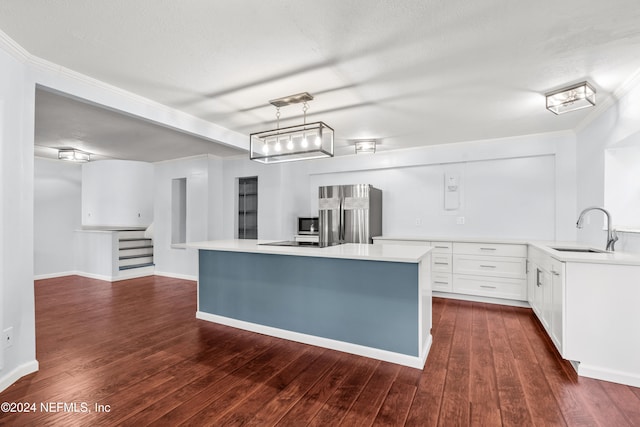 kitchen with light countertops, appliances with stainless steel finishes, dark wood-style flooring, and a sink