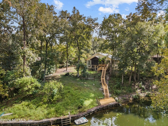 exterior space with a deck with water view and a boat dock