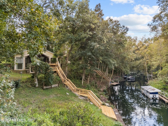 exterior space featuring a water view and a boat dock