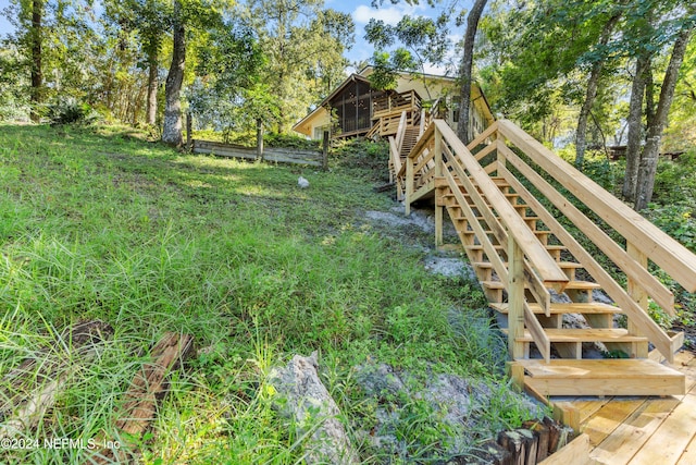 view of yard with a deck with water view