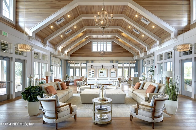 interior space with an inviting chandelier, plenty of natural light, wooden ceiling, and lofted ceiling with beams