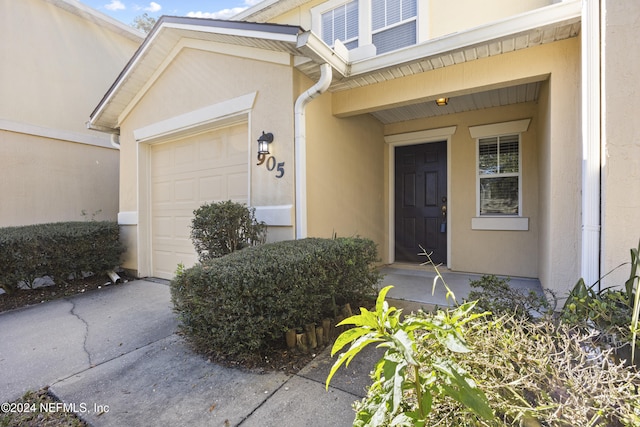 doorway to property featuring a garage