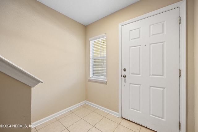 foyer entrance with light tile patterned floors