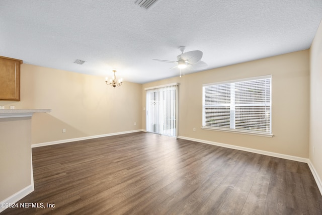 unfurnished room with dark hardwood / wood-style floors, a textured ceiling, and ceiling fan with notable chandelier