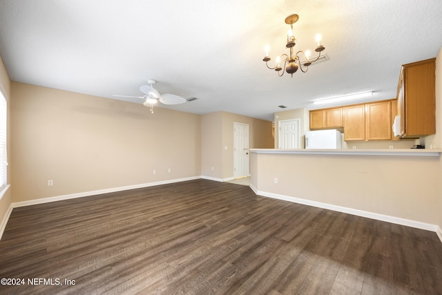 unfurnished living room with a textured ceiling, dark wood-type flooring, and ceiling fan with notable chandelier