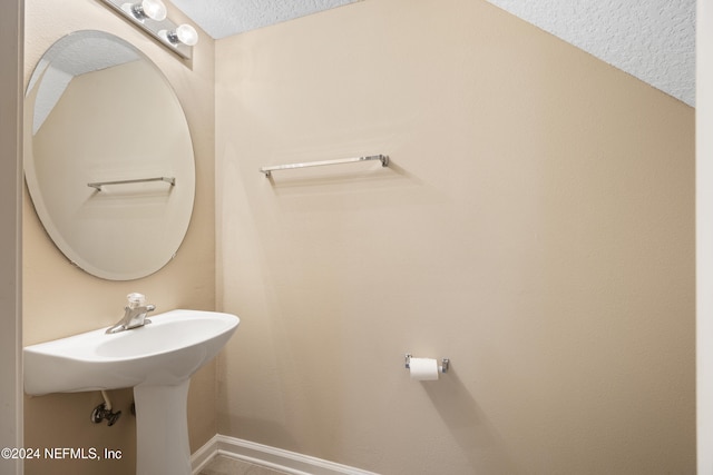 bathroom with a textured ceiling