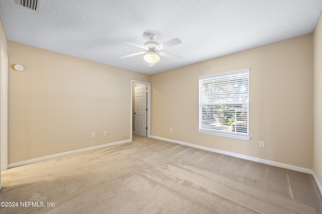 carpeted empty room with a textured ceiling and ceiling fan