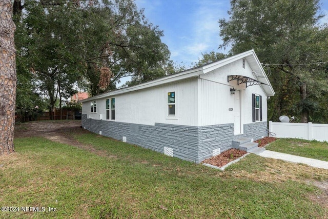 view of property exterior with a yard