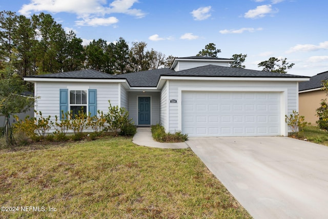 view of front of house featuring a garage and a front lawn