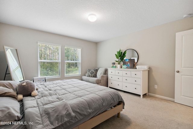 carpeted bedroom featuring a textured ceiling