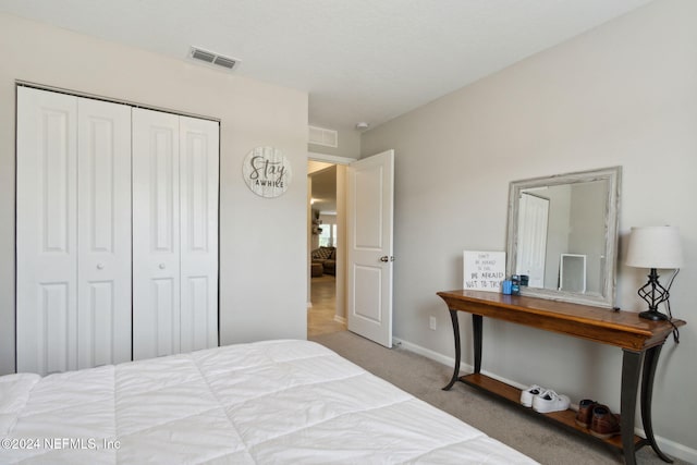 bedroom featuring a closet and light carpet