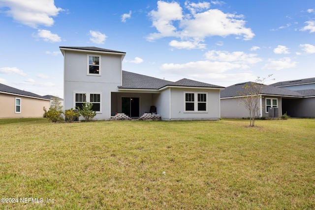 back of house with a yard