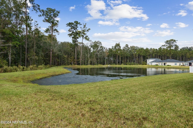 surrounding community featuring a lawn and a water view