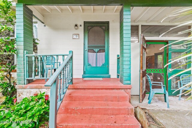 view of exterior entry with covered porch