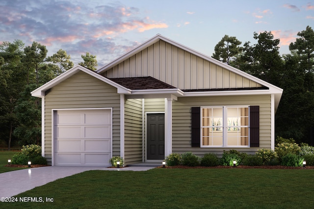 view of front of home with a lawn and a garage