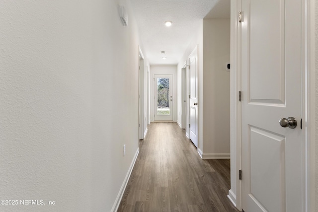 744 Hunter Rd, Hollister, FL 32177 - corridor with baseboards and dark wood-style flooring