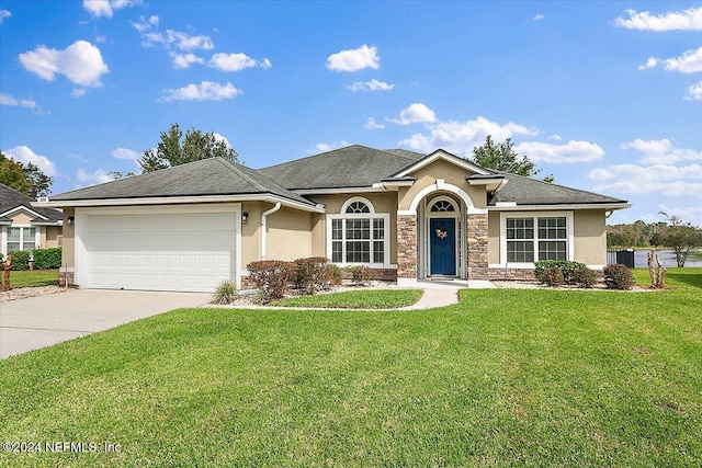 ranch-style house featuring a garage and a front lawn