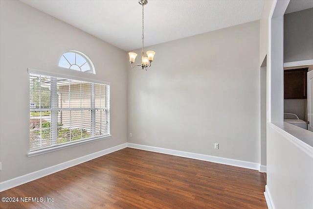 spare room featuring a textured ceiling, a chandelier, high vaulted ceiling, and dark hardwood / wood-style flooring