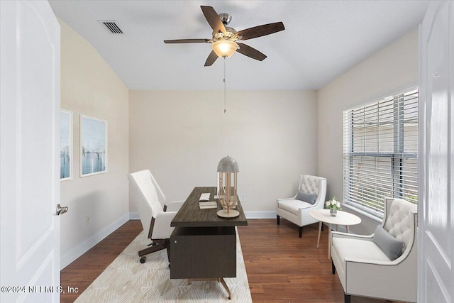 home office featuring dark wood-type flooring, ceiling fan, and plenty of natural light