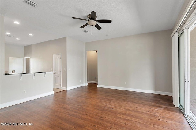 interior space with a textured ceiling, hardwood / wood-style flooring, and ceiling fan